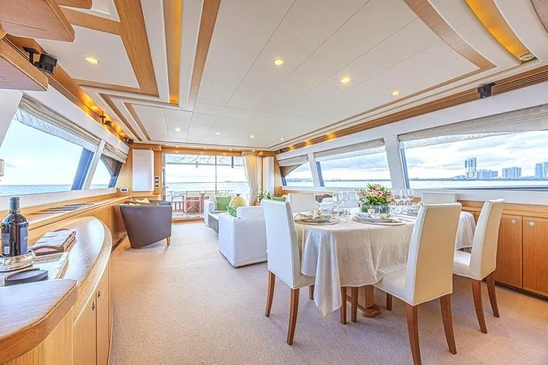 Noral Yacht Photos Pics Luxurious interior of 2011 Ferretti Yachts 830 with elegant dining area and panoramic windows.