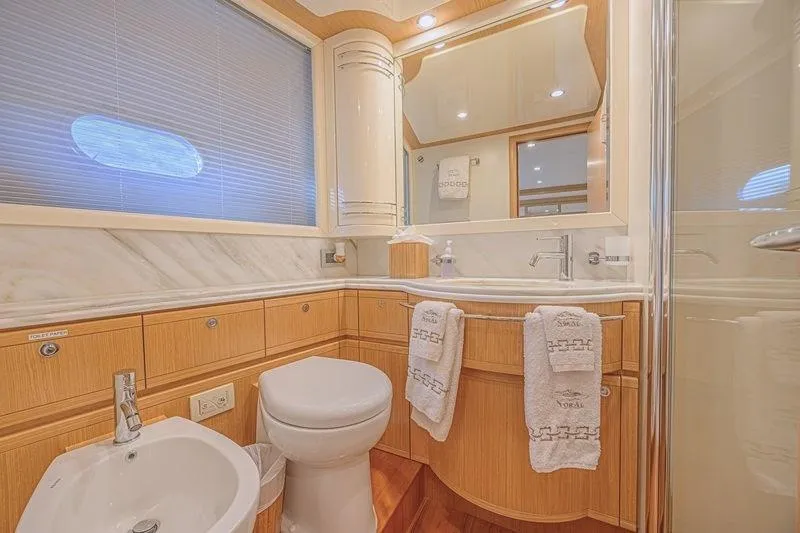 Noral Yacht Photos Pics Luxurious bathroom in 2011 Ferretti Yachts 830, featuring elegant wood cabinetry and modern fixtures.