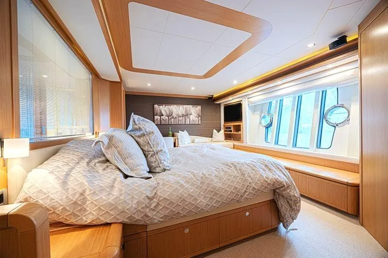 Noral Yacht Photos Pics Luxurious bedroom interior of 2011 Ferretti Yachts 830 with elegant wood finishes and large windows.