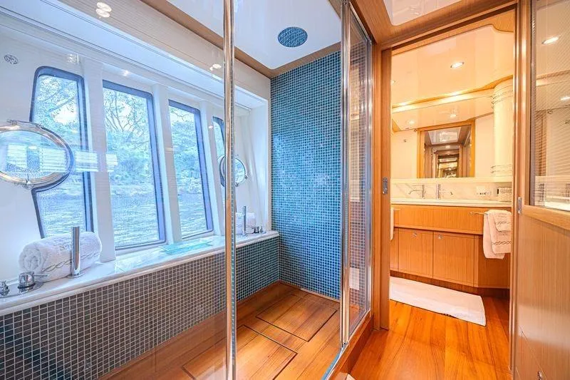 Noral Yacht Photos Pics Luxurious bathroom on 2011 Ferretti Yachts 830, featuring elegant wood and mosaic tile design.