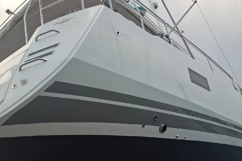  Yacht Photos Pics 2016 Jeanneau 64 yacht, sleek design, viewed from below, showcasing hull and deck details.