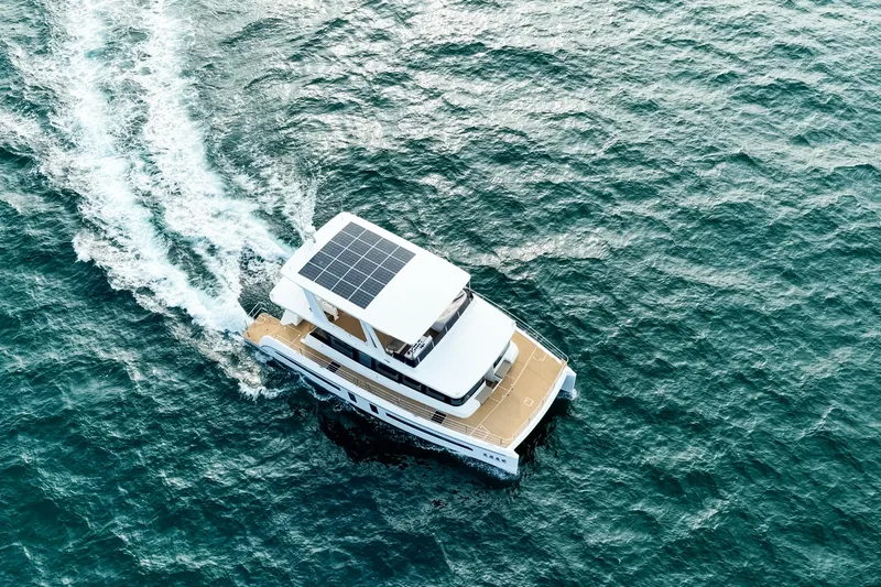  Yacht Photos Pics Aerial view of 2025 Mazarin 55 Catamaran with solar panels cruising on the ocean.