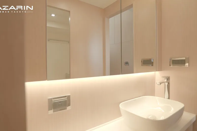  Yacht Photos Pics Luxurious bathroom interior of 2025 Mazarin 55 Catamaran, featuring modern sink and ambient lighting.