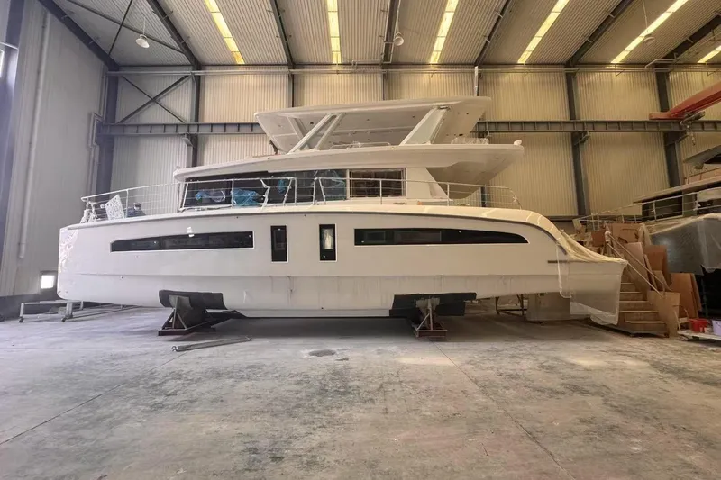  Yacht Photos Pics 2025 Mazarin 55 Catamaran Diesel in a spacious indoor facility.