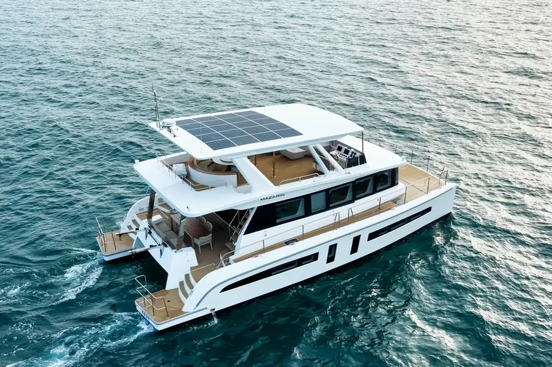  Yacht Photos Pics 2025 Mazarin 55 Catamaran Diesel cruising on open sea with solar panels on deck.