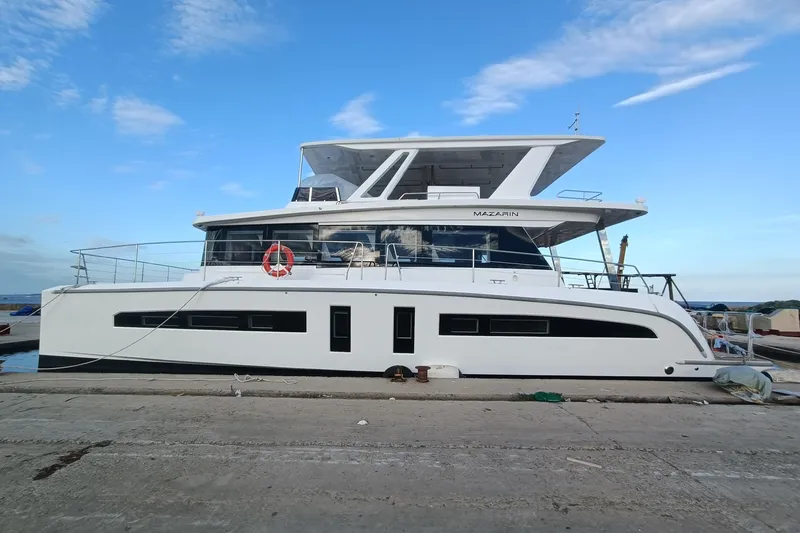  Yacht Photos Pics Luxury Mazarin 55 EVO II yacht docked, 2025 model, sleek design under clear blue sky.