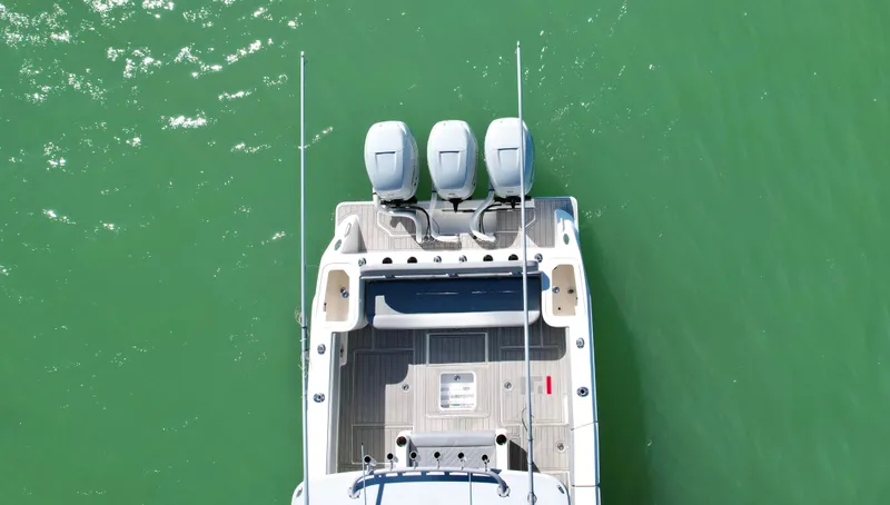  Yacht Photos Pics Aerial view of 2020 SeaVee 370z boat with triple engines on green water.