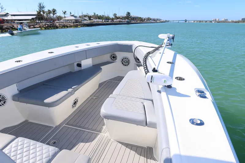  Yacht Photos Pics 2020 SeaVee 370z boat with spacious seating, docked in a serene marina.