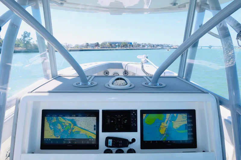  Yacht Photos Pics 2020 SeaVee 370z boat dashboard with navigation screens, steering, and ocean view.