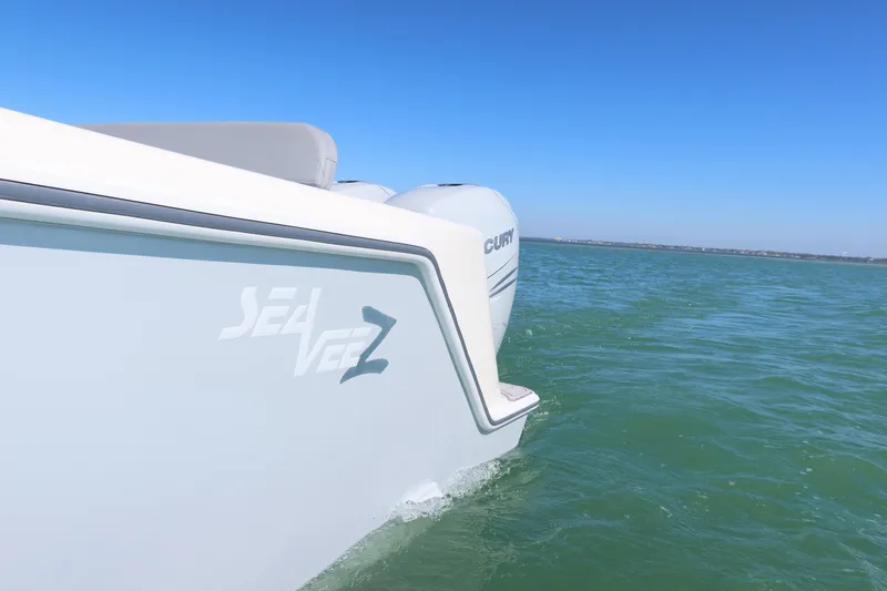  Yacht Photos Pics 2020 SeaVee 370z boat on calm ocean waters under clear blue sky.