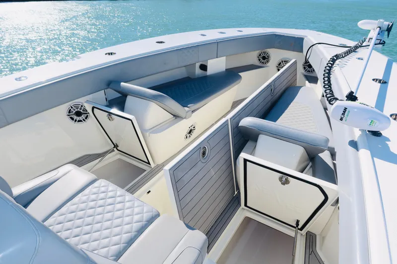  Yacht Photos Pics 2020 SeaVee 370z boat interior with cushioned seating and storage, on calm blue water.