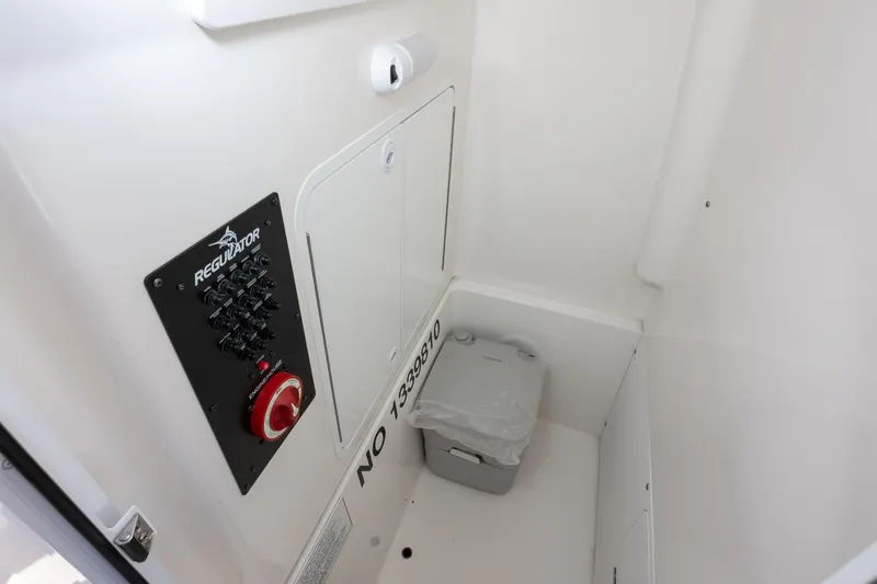 Our Trade Yacht Photos Pics 2024 Regulator 26XO boat interior with control panel and portable toilet.