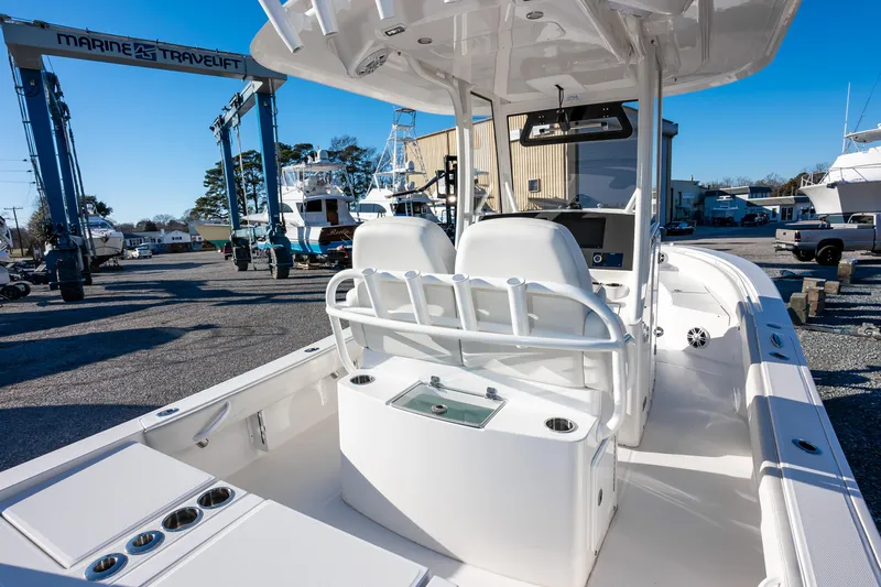 Our Trade Yacht Photos Pics 2024 Regulator 26XO boat interior at a marina, showcasing seating and console.