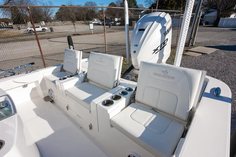 Our Trade Yacht Photos Pics 2024 Regulator 26XO boat interior with Yamaha V8 engine, featuring white seating and cup holders.