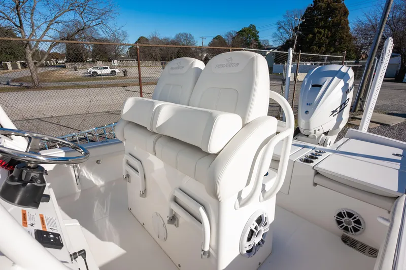 Our Trade Yacht Photos Pics 2024 Regulator 26XO boat interior with white seating and Yamaha outboard motor.