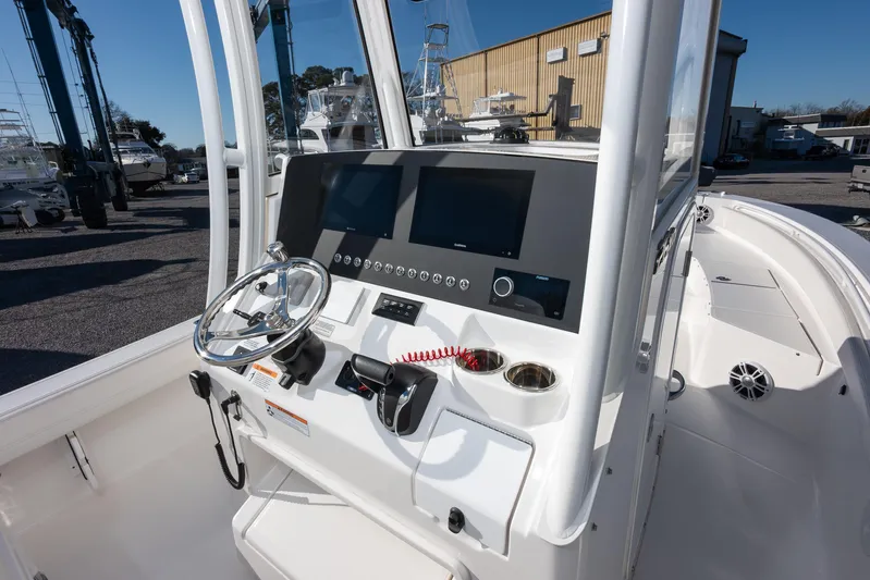 Our Trade Yacht Photos Pics 2024 Regulator 26XO boat console with steering wheel and navigation screens.