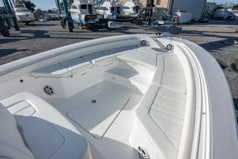 Our Trade Yacht Photos Pics 2024 Regulator 26XO boat interior with white seating and storage compartments.