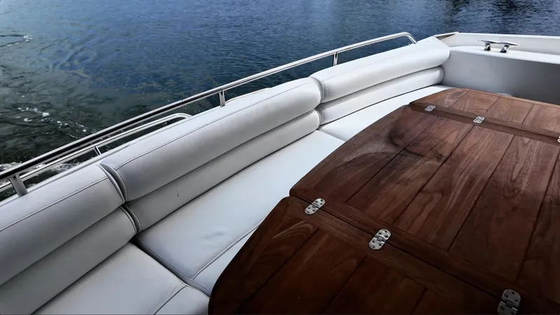 Itaca Yacht Photos Pics Luxurious seating area on a 2008 Sunseeker Manhattan 60 yacht with wooden table.