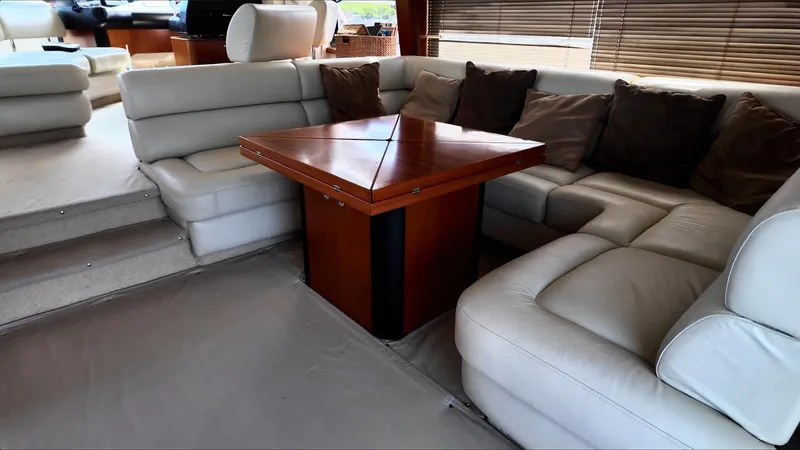 Itaca Yacht Photos Pics Luxurious interior of 2008 Sunseeker Manhattan 60 yacht with plush seating and wooden table.