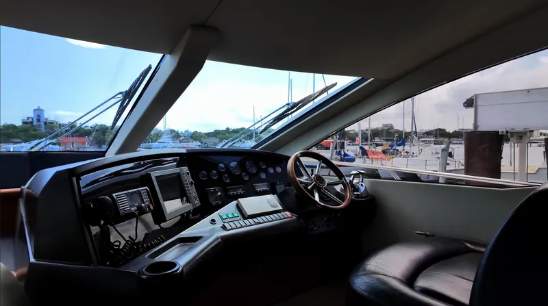 Itaca Yacht Photos Pics 2008 Sunseeker Manhattan 60 yacht helm with modern controls and marina view.