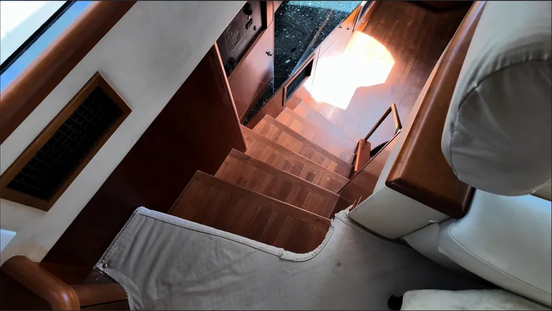 Itaca Yacht Photos Pics Interior stairs of 2008 Sunseeker Manhattan 60 yacht, featuring wooden steps and elegant design.