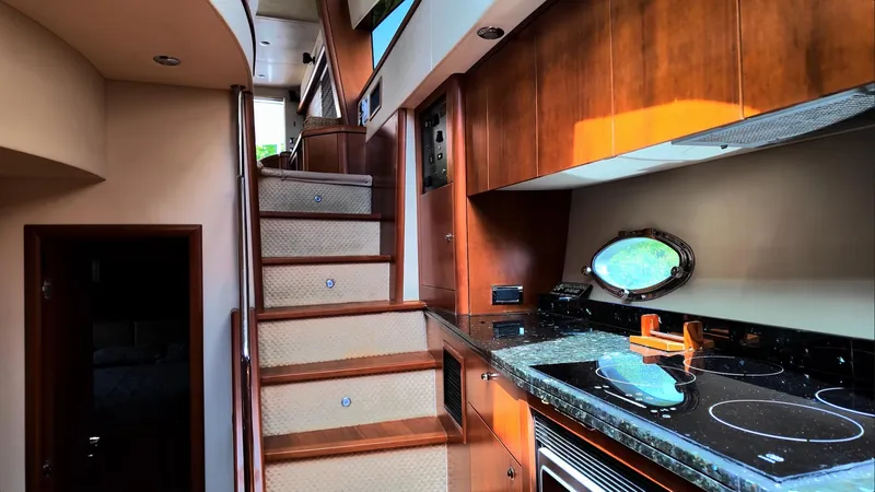 Itaca Yacht Photos Pics Luxurious interior of 2008 Sunseeker Manhattan 60 yacht with modern kitchen and staircase.