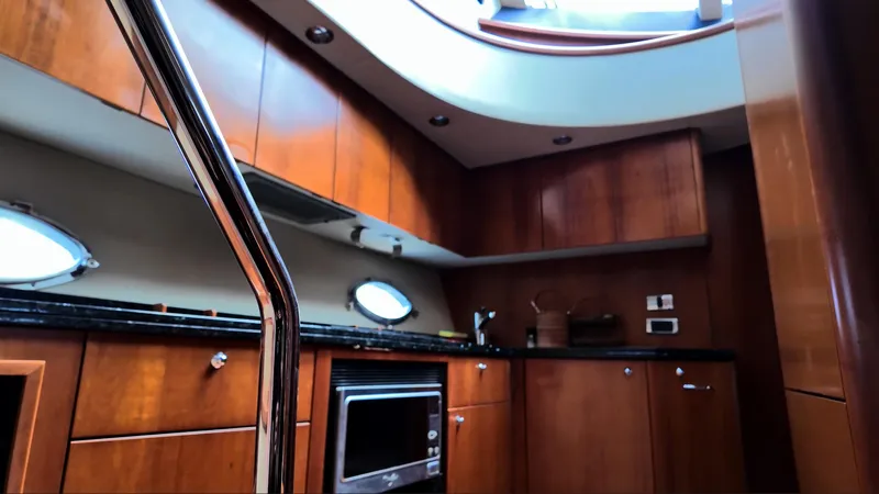 Itaca Yacht Photos Pics Luxurious kitchen interior of 2008 Sunseeker Manhattan 60 yacht with wood cabinetry.