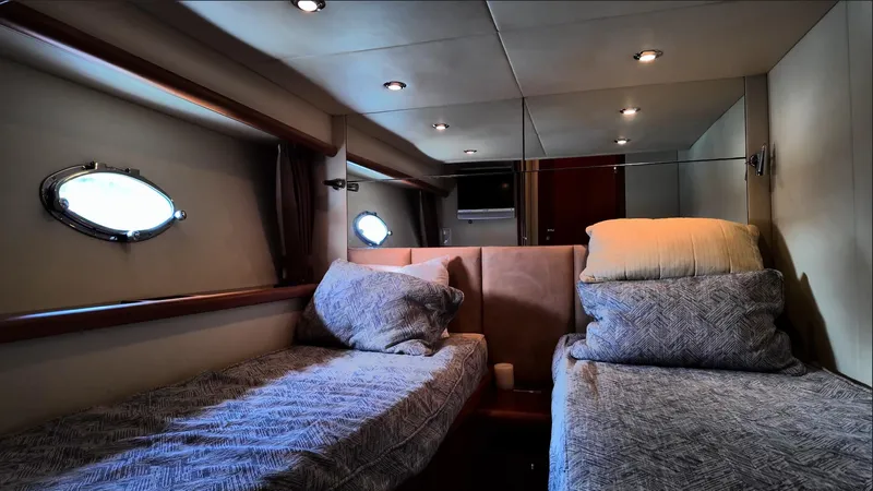 Itaca Yacht Photos Pics Luxurious cabin interior of 2008 Sunseeker Manhattan 60 yacht with twin beds.