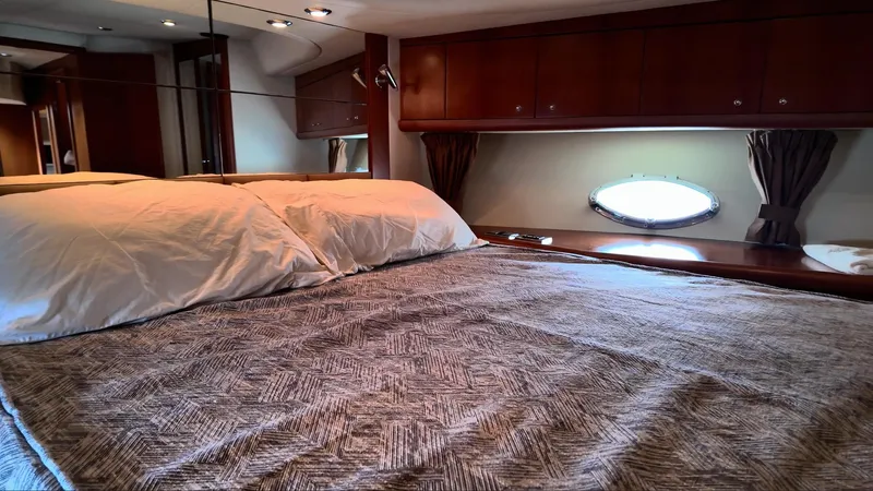 Itaca Yacht Photos Pics Luxurious bedroom interior of 2008 Sunseeker Manhattan 60 yacht with elegant wood finishes.