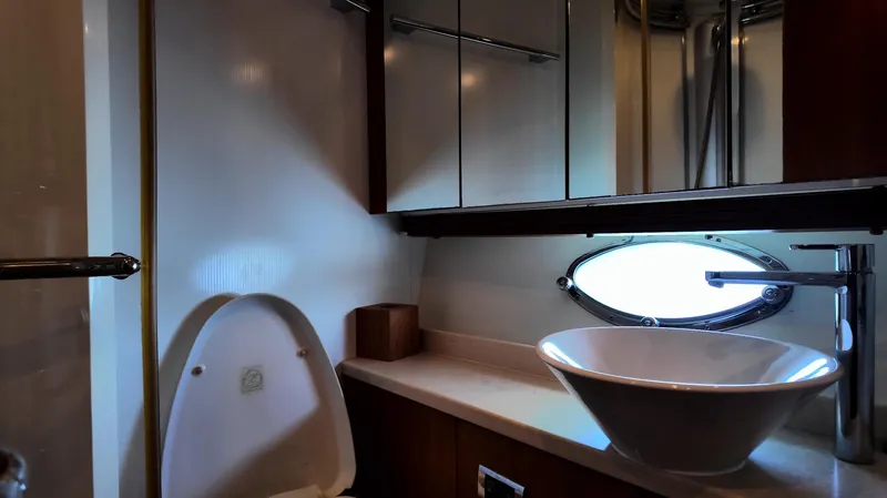 Itaca Yacht Photos Pics Luxurious bathroom in 2008 Sunseeker Manhattan 60 yacht with modern sink and porthole window.