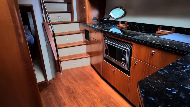 Itaca Yacht Photos Pics Luxurious kitchen interior of 2008 Sunseeker Manhattan 60 yacht with wooden cabinetry.