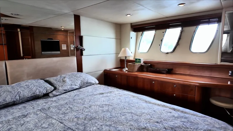 Itaca Yacht Photos Pics Luxurious bedroom interior of 2008 Sunseeker Manhattan 60 yacht with elegant wood finishes.