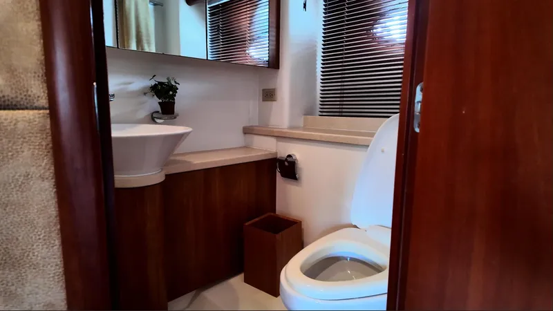 Itaca Yacht Photos Pics Luxurious bathroom in 2008 Sunseeker Manhattan 60 yacht with modern fixtures and wooden accents.