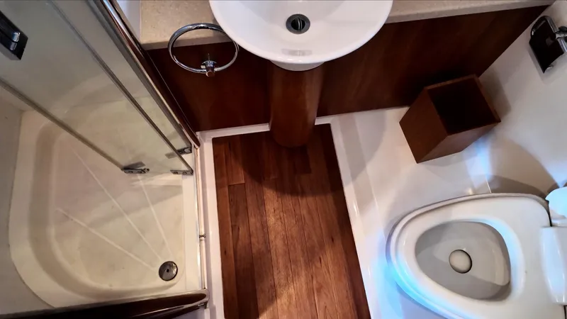 Itaca Yacht Photos Pics Bathroom interior of 2008 Sunseeker Manhattan 60 yacht with shower, sink, and toilet.
