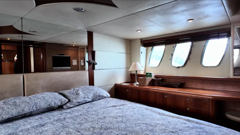 Itaca Yacht Photos Pics Luxurious bedroom interior of 2008 Sunseeker Manhattan 60 yacht with elegant wood finishes.