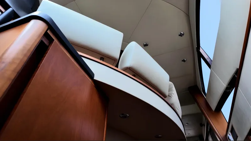 Itaca Yacht Photos Pics Interior view of 2008 Sunseeker Manhattan 60 yacht, featuring elegant wood and white upholstery.