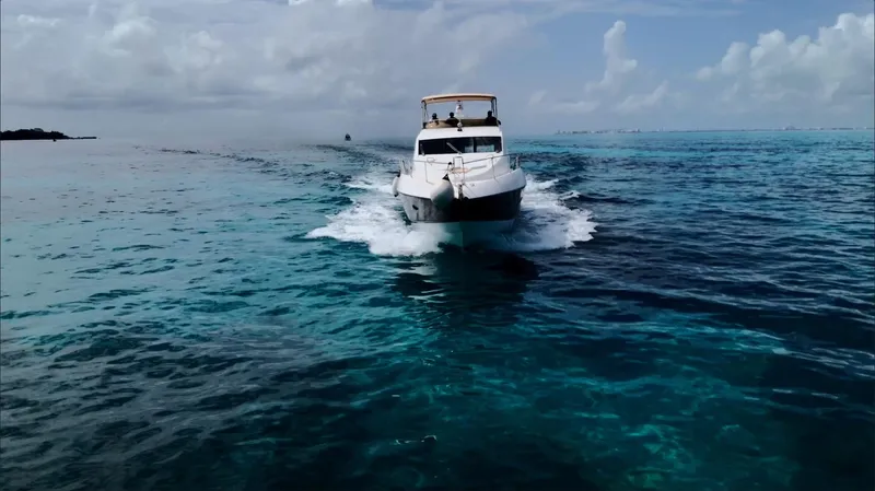 Itaca Yacht Photos Pics 2008 Sunseeker Manhattan 60 yacht cruising on clear blue ocean waters.