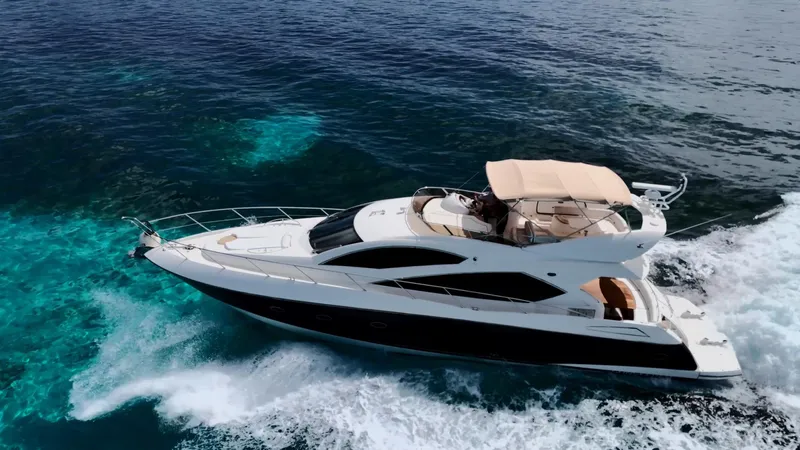 Itaca Yacht Photos Pics Luxury Sunseeker Manhattan 60 yacht cruising on clear blue ocean, 2008 model.