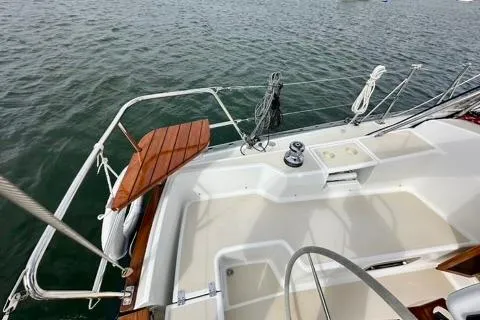 Blue Aweigh Yacht Photos Pics 2021 Tartan 345 sailboat deck with winch, ropes, and wooden accents on calm water.