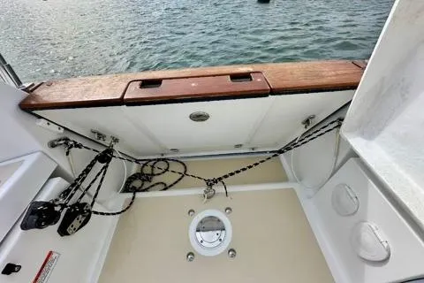 Blue Aweigh Yacht Photos Pics Tartan 345 boat deck, 2021 model, featuring ropes and wooden trim by the water.