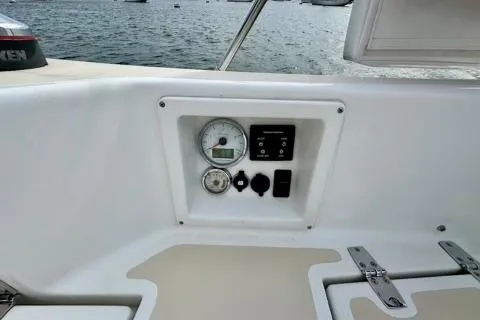 Blue Aweigh Yacht Photos Pics Control panel on 2021 Tartan 345 boat, featuring gauges and switches, with water view.