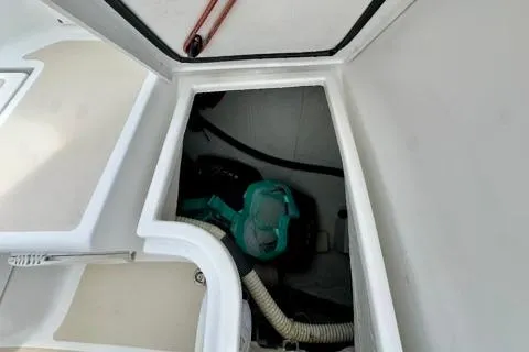Blue Aweigh Yacht Photos Pics Storage compartment in a 2021 Tartan 345 boat, featuring equipment and hoses.