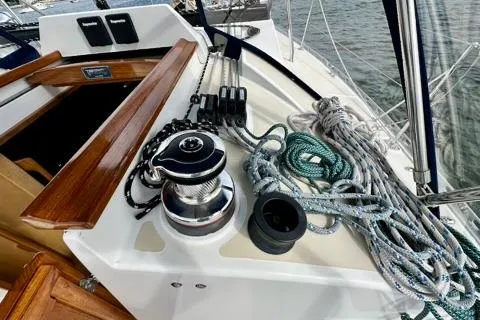 Blue Aweigh Yacht Photos Pics 2021 Tartan 345 sailboat deck with winch, ropes, and wooden hatch detail.