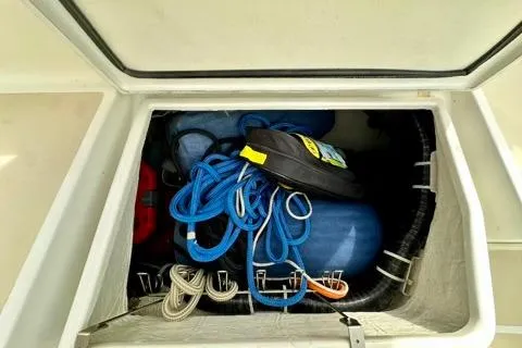 Blue Aweigh Yacht Photos Pics Storage compartment in a 2021 Tartan 345 boat with ropes and equipment.