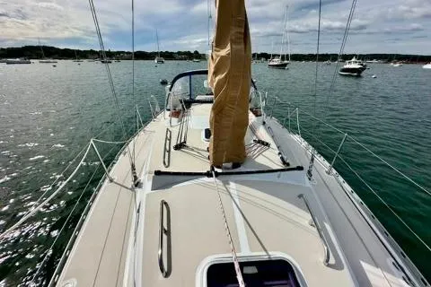 Blue Aweigh Yacht Photos Pics Sailing yacht Tartan 345, 2021 model, on calm waters with other boats in the background.