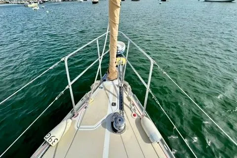 Blue Aweigh Yacht Photos Pics Bow view of 2021 Tartan 345 sailboat on calm water.