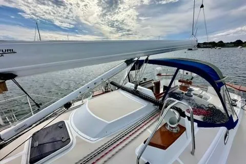 Blue Aweigh Yacht Photos Pics 2021 Tartan 345 sailboat deck with blue canopy and scenic water view.