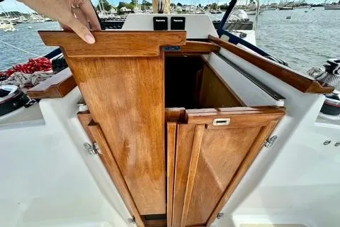 Blue Aweigh Yacht Photos Pics 2021 Tartan 345 sailboat with wooden cabin doors, docked by the water.