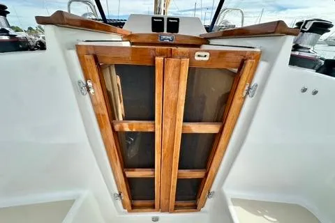 Blue Aweigh Yacht Photos Pics 2021 Tartan 345 sailboat with wooden cabin doors, showcasing elegant craftsmanship.