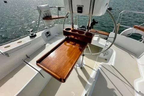 Blue Aweigh Yacht Photos Pics Cockpit of 2021 Tartan 345 sailboat with wooden table and steering wheel.